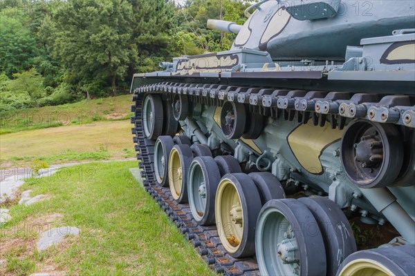 Closeup of wheels and track of military tank on display in public park in Nonsan, South Korea, Asia