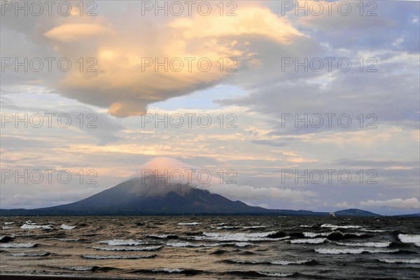 Lake Nicaragua, Ometepe Island in the background, Nicaragua, The sunset colours the sky and lake next to volcanoes in warm tones, Central America, Central America