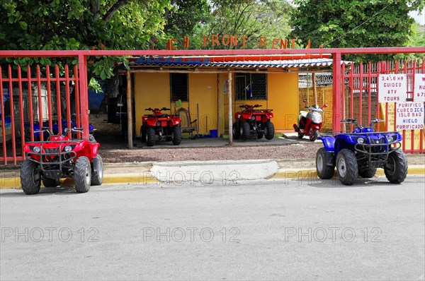 San Juan del Sur, Nicaragua, four-wheel drive vehicles for hire, parked in front of a colourful building with a fence, Central America, Central America