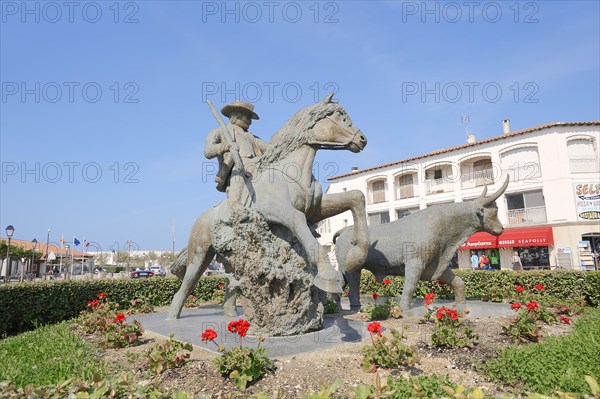 Statue of a drover with Camargue horse and Camargue bull, Les Saintes-Maries-de-la-Mer, Camargue, Bouches-du-Rhone, Provence-Alpes-Cote d'Azur, South of France, France, Europe