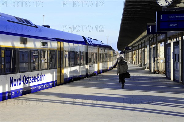Nord-Ostsee-Bahn, Station platform with a Nord-Ostsee-Bahn train and a person walking along, Sylt, North Frisian Island, Schleswig Holstein, Germany, Europe