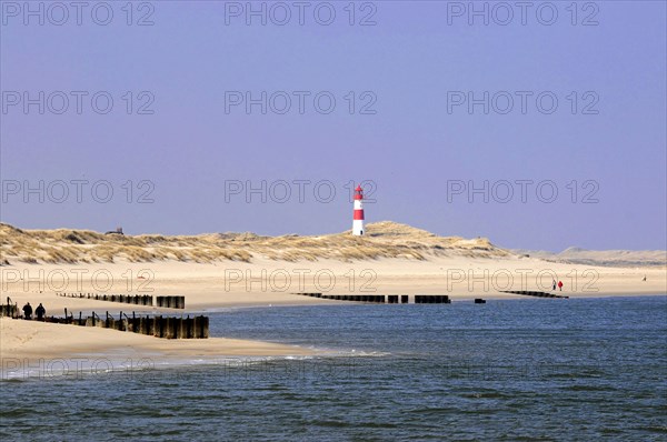 Lighthouse near List, at the Ellenbogen, Sylt, North Frisian Island, Schleswig Holstein, A lighthouse stands in the distance on a sandbank next to the blue sea, Sylt, North Frisian Island, Schleswig Holstein, Germany, Europe