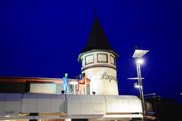 Evening, Westerland, Sylt, Schleswig-Holstein, A tower with figures on the balcony illuminated during the blue hour, Sylt, North Frisian Island, Schleswig Holstein, Germany, Europe