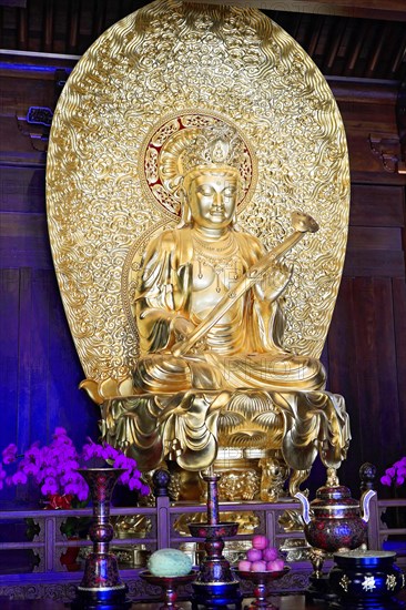Jade Buddha Temple, Shanghai, Golden Buddha statue in sitting pose, surrounded by religious ornaments, Shanghai, China, Asia