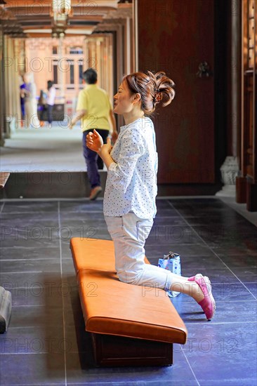 Jade Buddha Temple, Shanghai, A woman prays reverently in a quiet temple interior, Shanghai, China, Asia