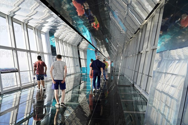 Observation deck, The Bottle Opener at 492 metres, people walking on a glass floor of an observation deck in a skyscraper with reflections, Shanghai, China, Asia