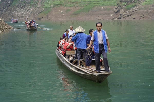 Special boats for the side arms of the Yangtze, for the tourists of the river cruise ships, Yichang, China, Asia, people travelling in a small boat on a calm river with green hills in the background, Hubei province, Asia