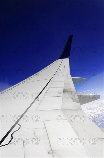 View upwards to an aeroplane wing with clear blue sky in the background, AUGUSTO C. SANDINO Airport, Managua, Nicaragua, Central America, Central America