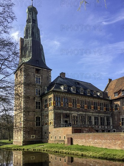 View of tower and main wing of historic moated castle from Renaissance Raesfeld Castle, in the foreground moat Freiheit Raesfeld, excursion destination in North Rhine-Westphalia, Muensterland, North Rhine-Westphalia, Germany, Europe