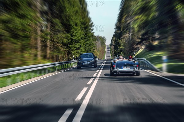 Zoom effect, country road near Boerwang with old MG sports car, Allgaeu, Swabia, Bavaria, Germany, Europe