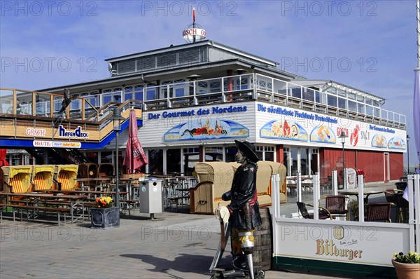 Harbour of List, North Sea island of Sylt, North Frisia, Schleswig-Holstein, A restaurant by the sea with a pirate statue and a terrace, Sylt, North Frisian island, Schleswig Holstein, Germany, Europe