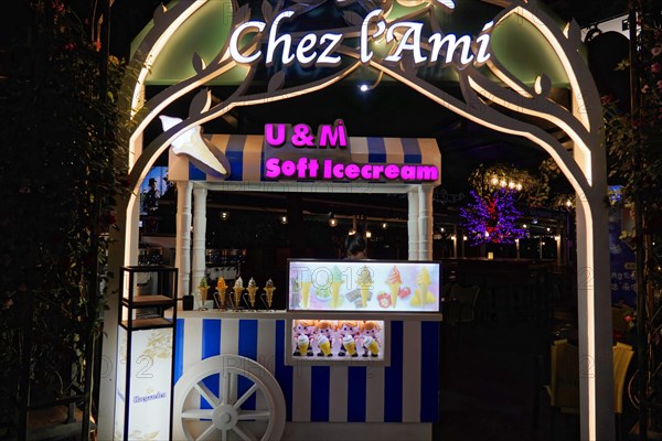 Shanghai by night, China, Asia, Illuminated ice cream van in front of a street cafe in the city at night with tasteful decoration, Shanghai, Asia