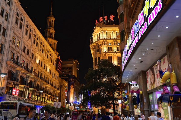 Evening stroll through Shanghai to the sights, Shanghai, Colourful plastic figure in comic style, playing football and attached to the wall of a shop front, Shanghai, People's Republic of China