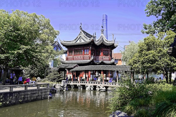 Excursion to Zhujiajiao Water Village, Shanghai, China, Asia, visitors explore a traditional Chinese garden with a pavilion by the water, Asia