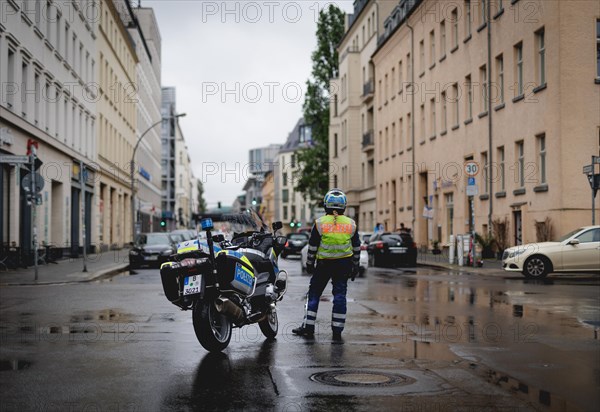 Policewoman with motorbike blocks road, taken during a demonstration in Berlin, 19/04/2024