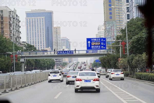 Xian, Shaanxi, China, Asia, city motorway with moving cars and road signs, surrounded by buildings, Asia