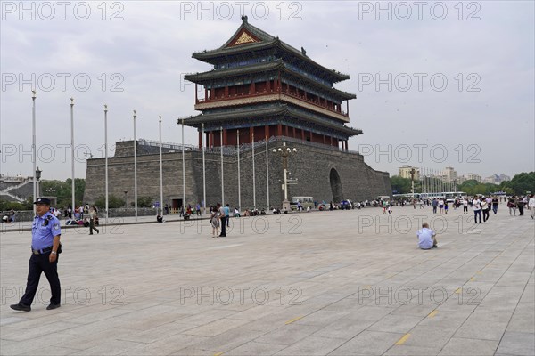 Beijing, China, Asia, Large square with old building and people walking under a cloudy sky, Asia