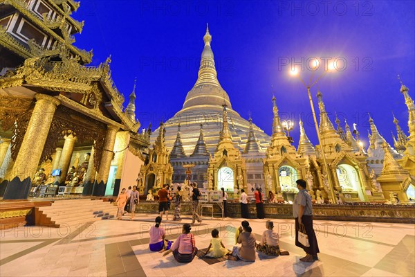 Shwedagon Pagoda, Yangon, Myanmar, Asia, Group of people in the evening in front of the impressive Shwedagon Pagoda, Asia