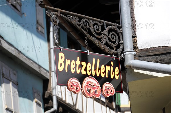 Eguisheim, Alsace, France, Europe, A sign with a pretzel motif representing a speciality of the shop, Europe