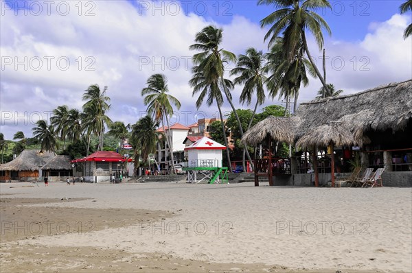 San Juan del Sur, Nicaragua, beach with palm trees and huts, cloudy sky, tropical tourism sign, Central America, Central America