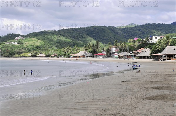San Juan del Sur, Nicaragua, Cloudy sky over a quiet beach with green mountain landscape in the background, Central America, Central America