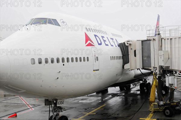 AUGUSTO C. SANDINO Airport, Managua, Nicaragua, A Delta aircraft at the gate connected to a passenger boarding bridge, Central America, Central America