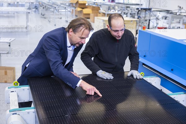 Sunmaxx PVT is a new innovative developer of photovoltaic thermal solar modules. The Fraunhofer ISE has confirmed an overall efficiency of 80% for the PX-1 premium module. The innovation is the combination of photovoltaics and solar thermal energy in one element. Dr Jiri Springer Chief Technology Officer (CTO) and employee Emad Sidhorn at a PVT module, Ottendorf-Okrilla, Saxony, Germany, Europe