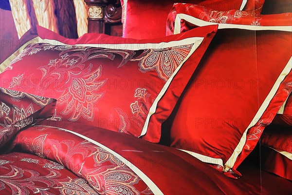 Silk factory Shanghai, Red satin cushions with golden embroidery on a bed in detail, Shanghai, China, Asia
