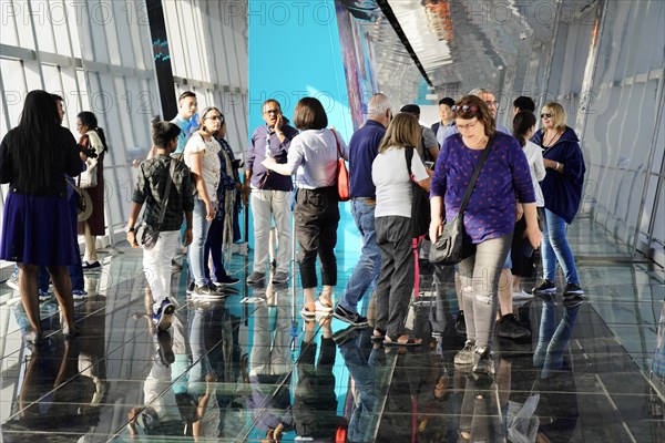 Viewing terrace, The Bottle Opener at 492 metres, A group of people stand in a modern glass building with many reflections, Shanghai, China, Asia