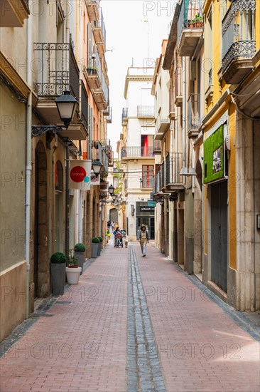 Narrow streets with shops in the city centre of Figueras, Spain, Europe