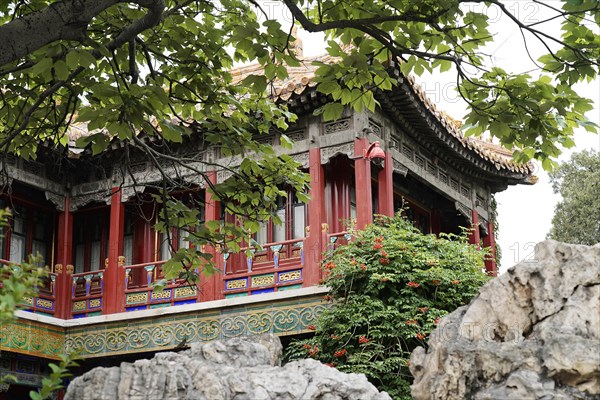 China, Beijing, Forbidden City, UNESCO World Heritage Site, A traditional Chinese building embedded in lush greenery and rocks, Forbidden City (Palace Museum) in Beijing, China, Asia