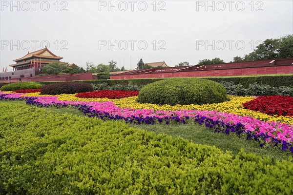 China, Beijing, Forbidden City, UNESCO World Heritage Site, Colourful flower beds against the background of the Forbidden City and a cloudy sky, Asia