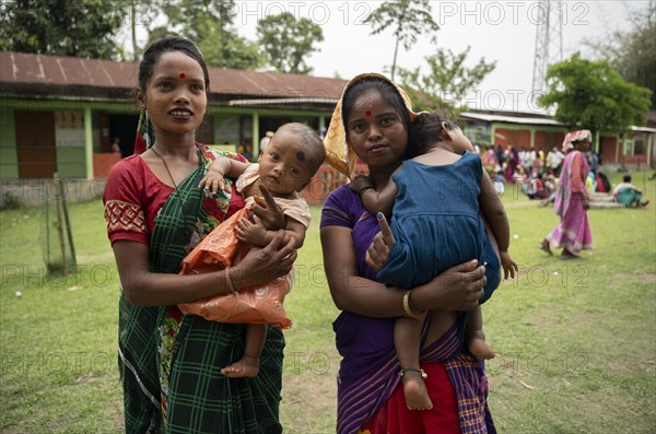 BOKAKHAT, INDIA, APRIL 19: Women with child show their marked finger after casting their votes during the first phase of the India's general elections on April 19, 2024 in Bokakhat, Assam, India. Nearly a billion Indians vote to elect a new government in six-week-long parliamentary polls starting today