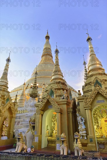 Shwedagon Pagoda, Yangon, Myanmar, Asia, Detailed view of several golden stupas and statues at the Shwedagon Pagoda under a blue sky, Asia