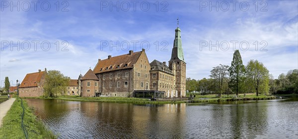 Panoramic photo View over moat to historic moated castle from Renaissance Raesfeld Castle reflected in moat in spring, Freiheit Raesfeld, Muensterland, North Rhine-Westphalia, Germany, Europe
