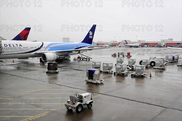 AUGUSTO C. SANDINO AIRPORT, Managua, Nicaragua, A Delta Airlines plane parked at the wet airport under grey skies, Central America, Central America