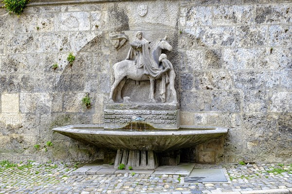The Martin Fountain at the northeast corner of St. Martin's Church in Memmingen in Unterallgaeu, Swabia, Bavaria, Germany, Europe
