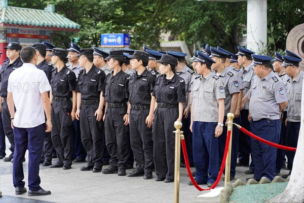 Chongqing, Chongqing Province, China, Asia, Police officers in uniform stand in a formation and radiate seriousness, Asia