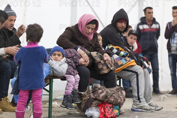 A Syrian refugee family and their children wait in a tent at the Berlin State Office for Health and Social Affairs for their registration, 15 October 2015, Berlin, Berlin, Germany, Europe