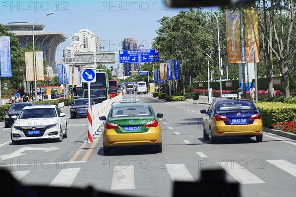 Beijing, China, Asia, city scene with several cars on the street and clear blue sky in the background, Asia