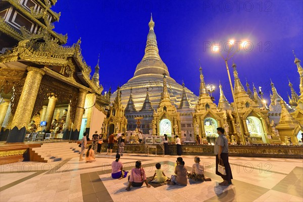 Shwedagon Pagoda, Yangon, Myanmar, Asia, visitors surrounded by golden structures of the pagoda at dusk, filled with tranquillity, Asia