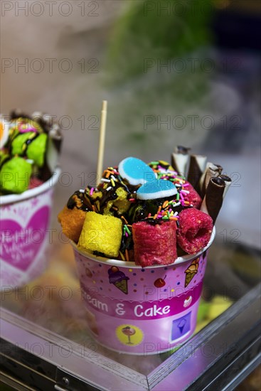 Ice cream sundae with cake on a market stall, sweets, sugar, unhealthy, colourful, gaudy, colourful, decorated, decoration, enough, sweet, colourful, market, food, Asian, market, sale, trade, economy, tourism, travel, Thailand, Asia