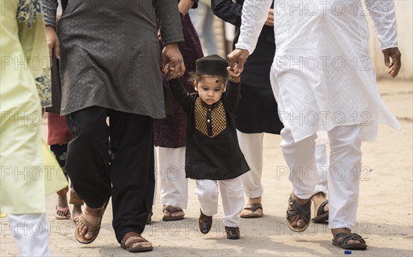 GUWAHATI, INDIA, APRIL 11: Muslim people with children walk towards an Eidgah to perform Eid Al-Fitr prayer in Guwahati, India on April 11, 2024. Muslims around the world are celebrating the Eid al-Fitr holiday, which marks the end of the fasting month of Ramadan