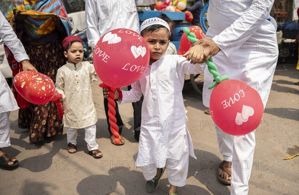 GUWAHATI, INDIA, APRIL 11: Muslim people with children walk towards an Eidgah to perform Eid Al-Fitr prayer in Guwahati, India on April 11, 2024. Muslims around the world are celebrating the Eid al-Fitr holiday, which marks the end of the fasting month of Ramadan