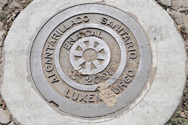 Leon, Nicaragua, A manhole cover with an inscription on a concrete pavement, Central America, Central America