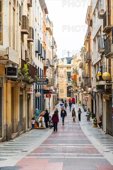 Narrow streets with shops in the city centre of Figueras, Spain, Europe