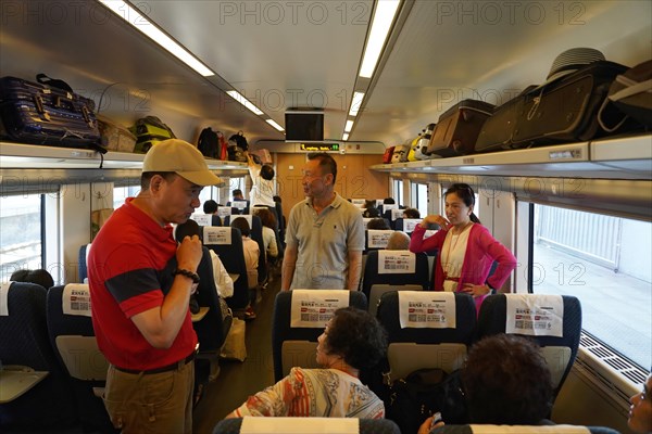 Express train CRH380 to Yichang, passengers standing and sitting in an illuminated train interior, Shanghai, Yichang, Yichang, Hubei Province, China, Asia