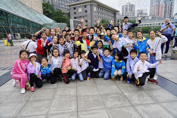 Chongqing, Chongqing Province, China, Asia, Joyful children pose together in an urban environment, Asia