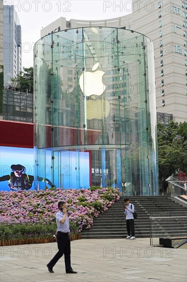 Strolling in Chongqing, Chongqing Province, China, Asia, People in front of an Apple Store with a large glass facade in a shopping district, Chongqing, Asia