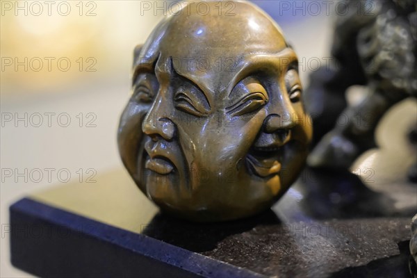 Xian, Shaanxi Province, China, Asia, A detailed bronze sculpture with two different faces and moods, Xian, Shaanxi Province, China, Asia